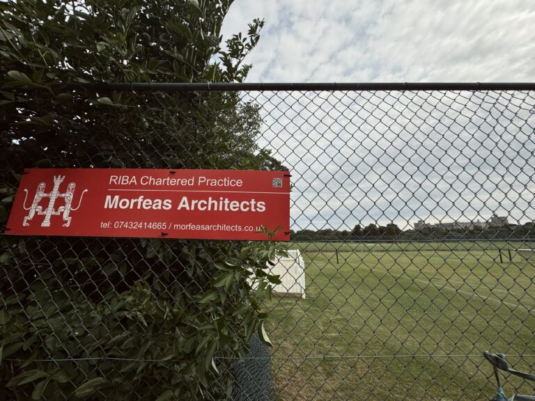 Red Morfeas architect's Signboard on the green backround of Home park trees, RIBA chartered practice